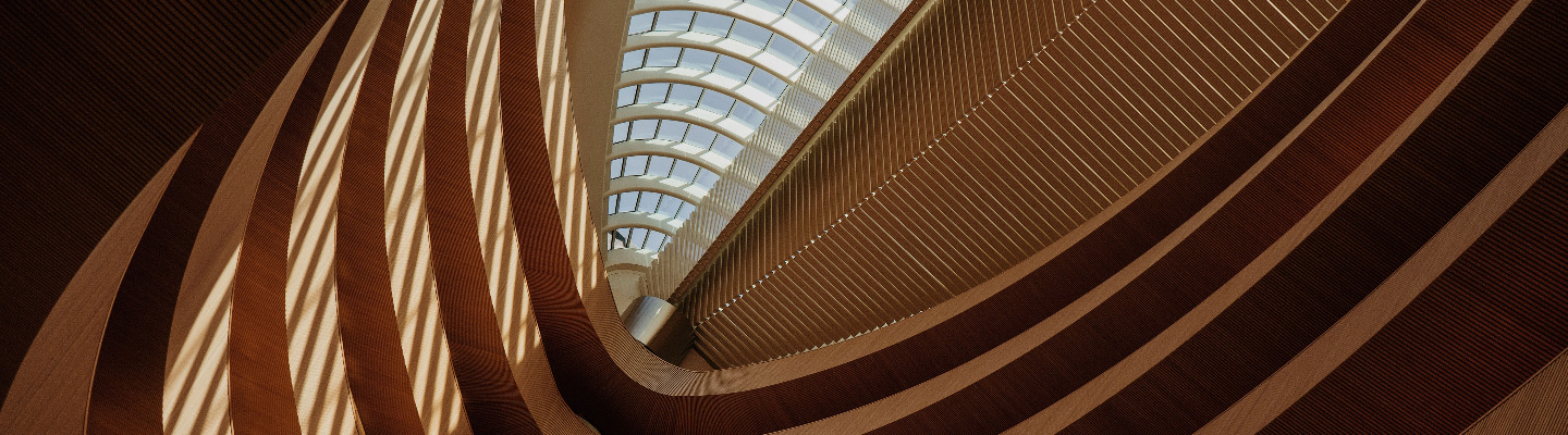 A view looking upwards of the internal structure of a modern building made from, timber and glass